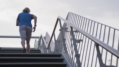 sporty caucasian man training on a bridge