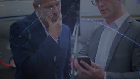 Animation-of-connections-over-caucasian-businessmen-with-smartphone-in-front-of-plane