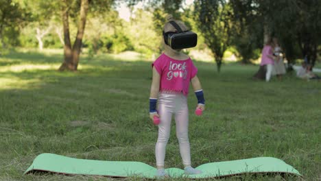 niña atlética con casco de auriculares vr haciendo ejercicios de fitness con pesas en el parque