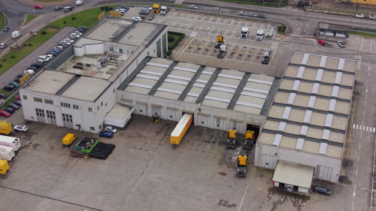 Aerial view of a semi-trailer truck docking at warehouse loading bay