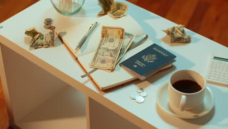 a caucasian woman takes her american passport off the coffee table