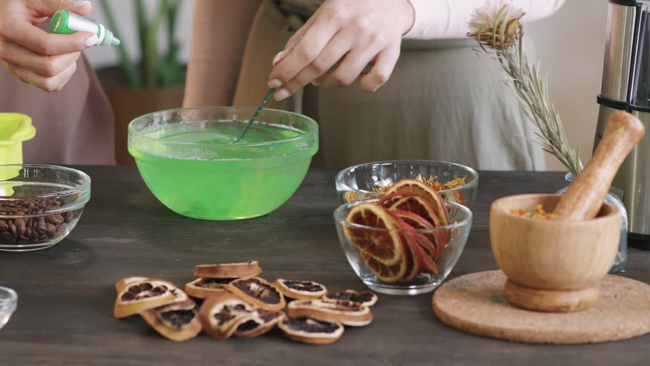 Adding Green Colorant To Bowl Of Water