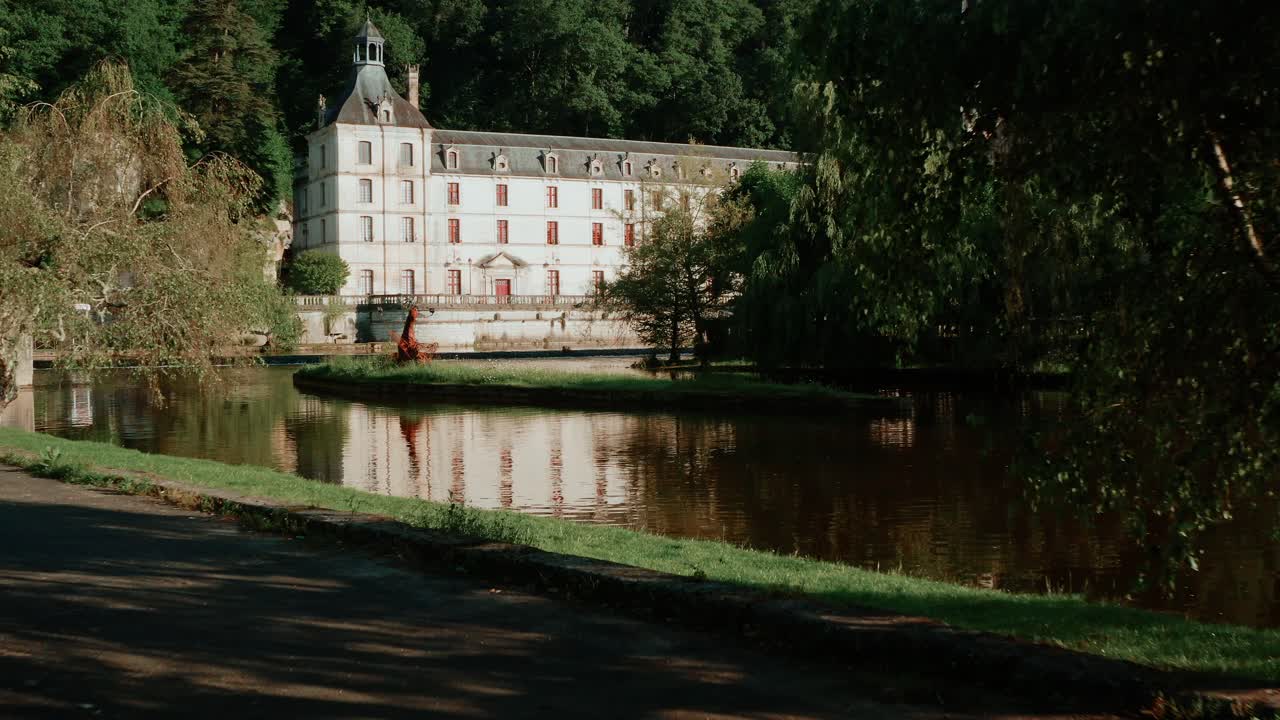 Traveling forward by drone from a public park to discover Brant&ocirc;me, a town near P&eacute;rigueux