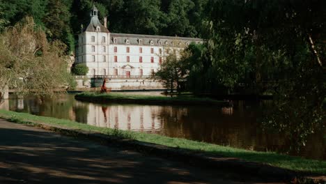 Traveling-forward-by-drone-from-a-public-park-to-discover-Brantôme,-a-town-near-Périgueux