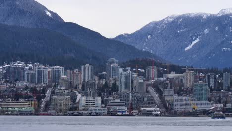 North-Vancouver-Cityscape-with-Ferryboat-Crossing,-Winter-Day