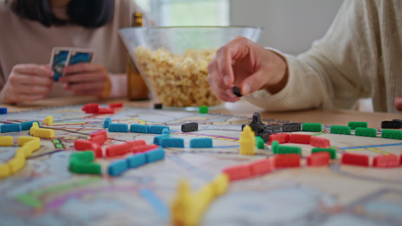 People hands playing board game at table closeup. Anonymous company house party