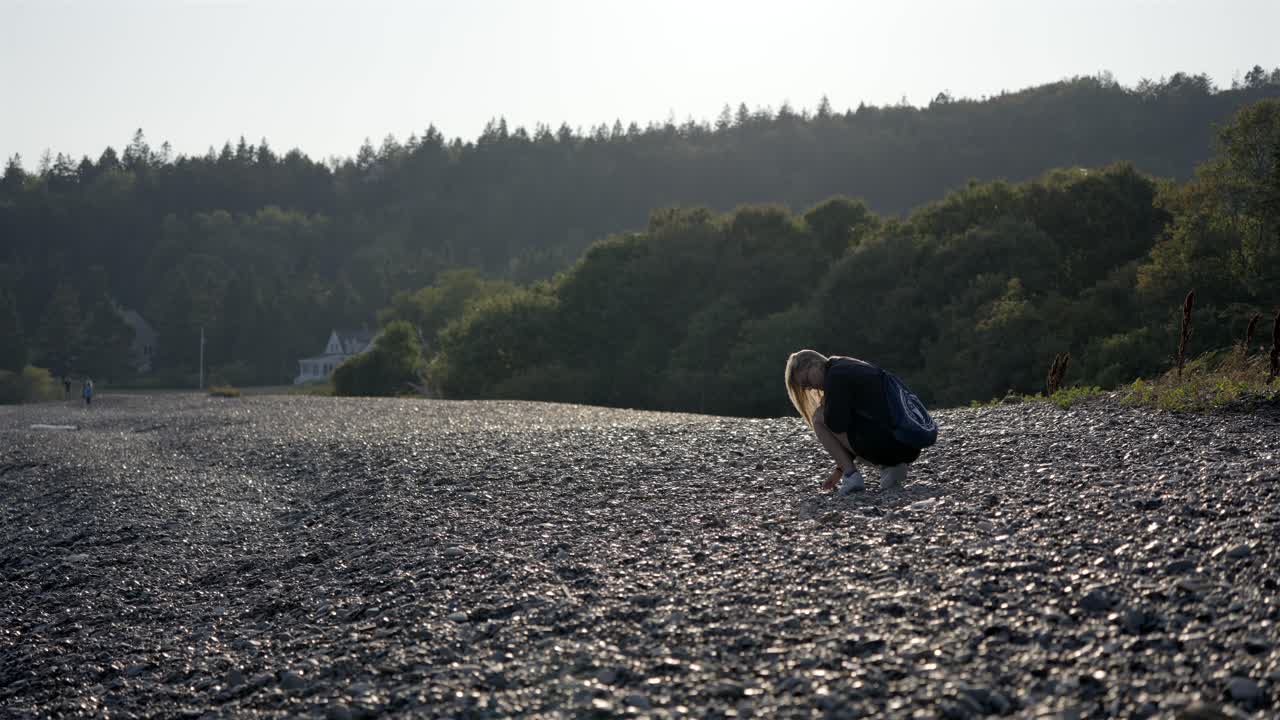 Collecting Polished Stones and Pebbles, a Hobby on a Quiet Seaside Beach