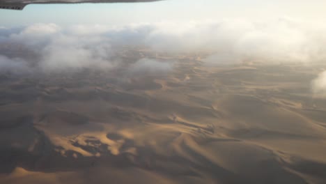 wide epic shot of namibian sossuvlei from a small airplane, with nice shadows and small clouds