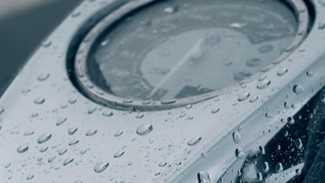 wonderful closeup vibrating raindrops on black motorbike