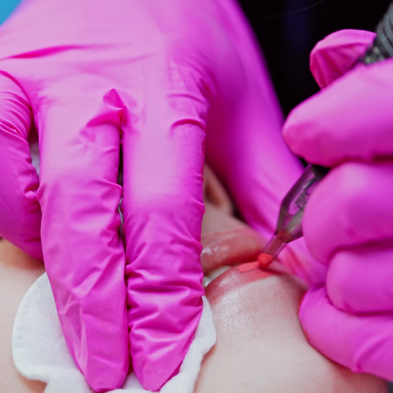 Modern cosmetology in beauty spa. Woman patient receives permanent make-up tattoo on lips in spa salon. Tattooist doing pigmentation of lips. Close-up.