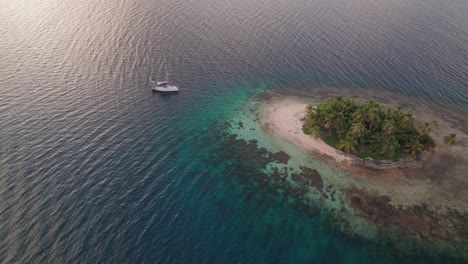 drone shot on sunset of a sailboat in a remote island in san blas archipelago