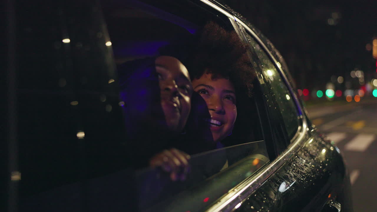 Two women enjoying a night ride