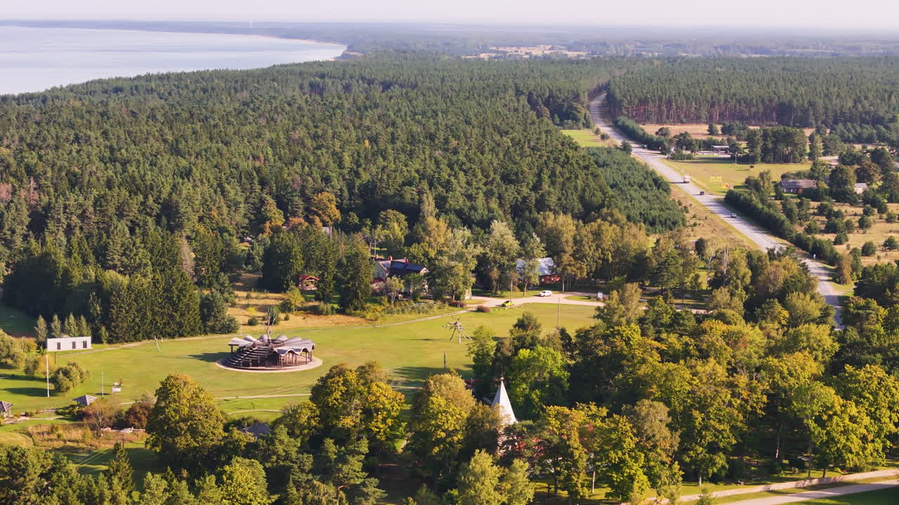 Drone footage of forest village, coast, and countryside road in Jurkalne Latvia.