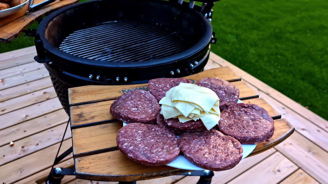 Hamburger Patties and Cheese Slices Prepared for Grilling at an Outdoor Barbecue