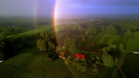 small countryside home on early morning misty landscape, aerial view