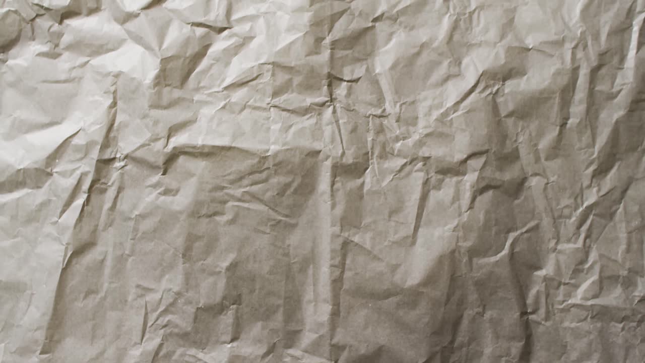 Video of close up of crumpled grey paper texture background