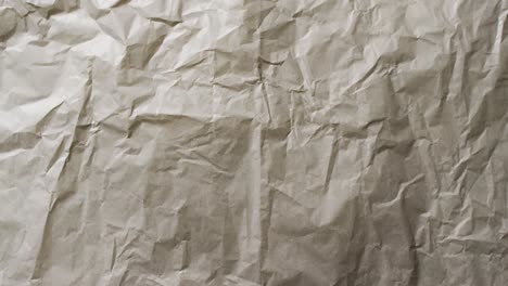 Video-of-close-up-of-crumpled-grey-paper-texture-background