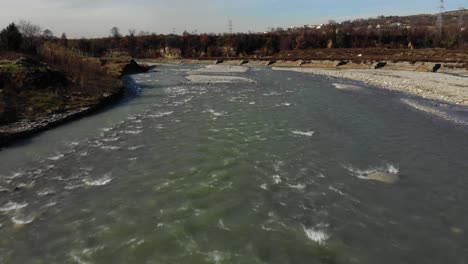 River-water-streaming-through-pebbled-riverbed,-canoe-floating-rafting-effect