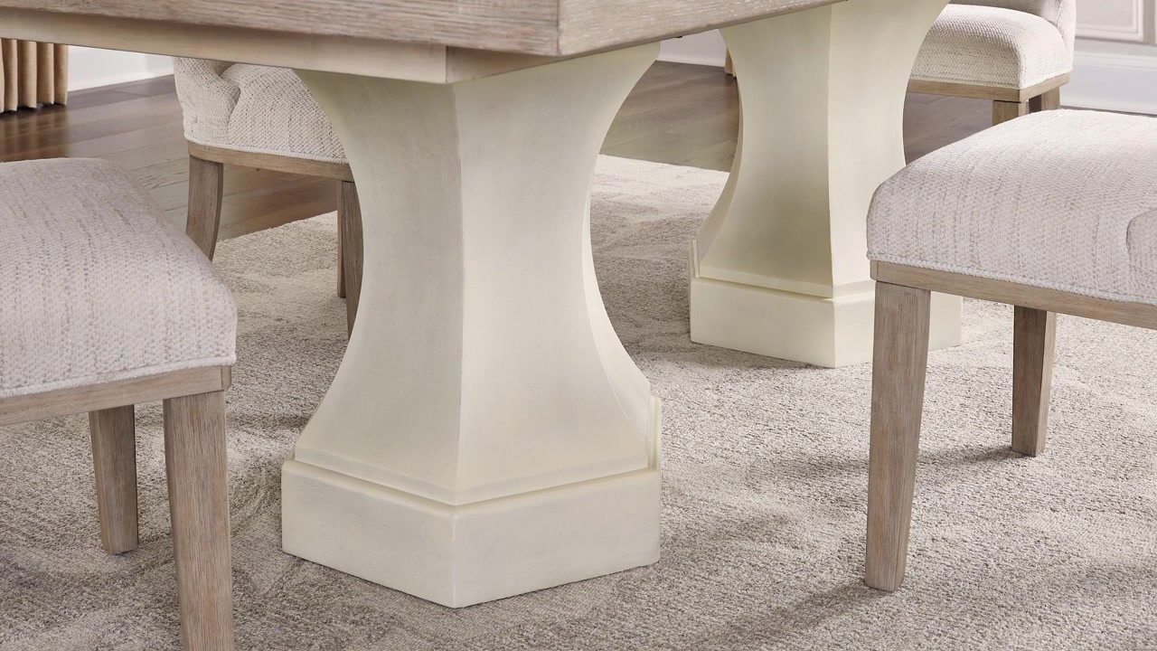Slow zoom out of the base of a rustic dining table showcasing wood craftsmanship and farmhouse design in a professionally staged dining room