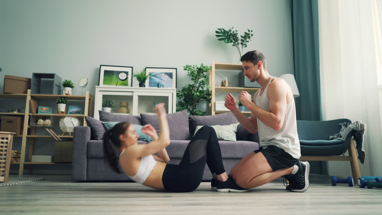 Couple Doing Sit-Ups at Home