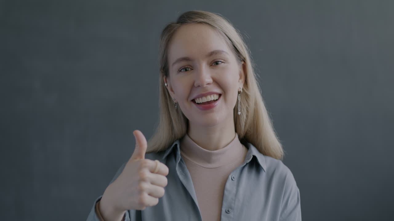 Woman Smiling and Giving a Thumbs Up