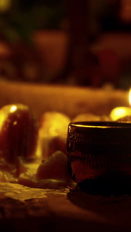 candlelit still life with a glass cup