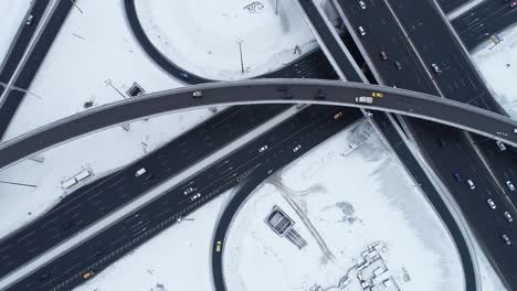 aerial view of a freeway intersection snow-covered in winter.