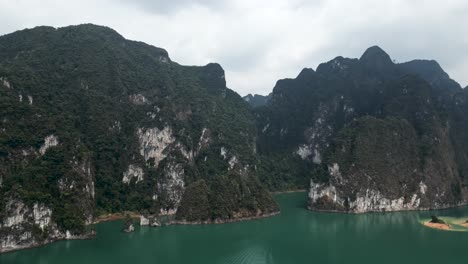 scenic tropical landscape of limestone karst mountains and green lake