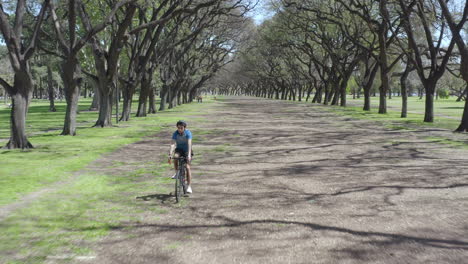 aerial shot of cyclist riding a bike in the park
