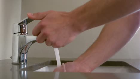 close up view of a man washing his hands