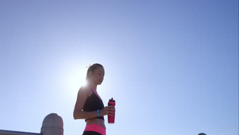 Runner-woman-cooling-off-with-water-bottle