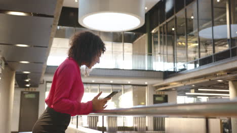 using tablet, woman working in modern office building, focusing on task, copy space