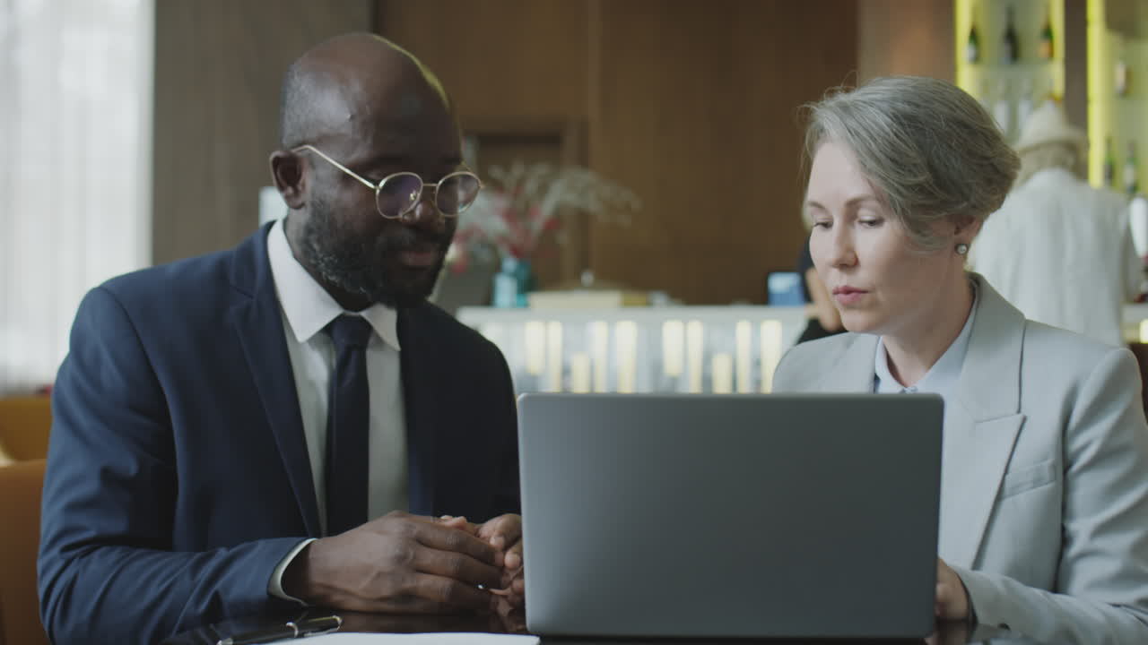 Colleagues Working on Laptop in Restaurant