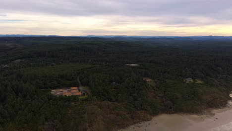 Drone-Reveal-Shot-Of-Calm-Beach-At-Seven-Devils-State-Recreation-Site-In-Bandon,-Oregon-At-Sunset