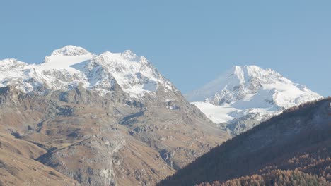 mountains with snow on their peaks in the autumn light