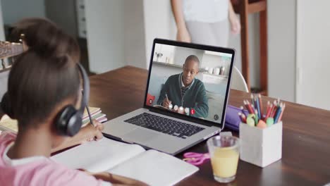 Composition-of-african-american-schoolgirl-on-laptop-online-learning-and-african-american-schoolboy