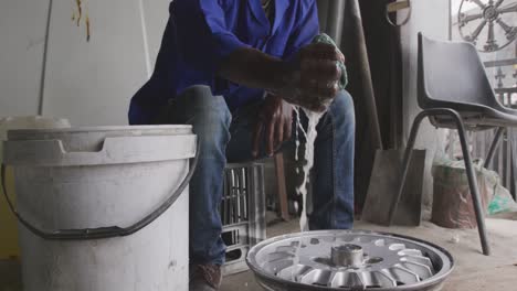 african man cleaning a wheel