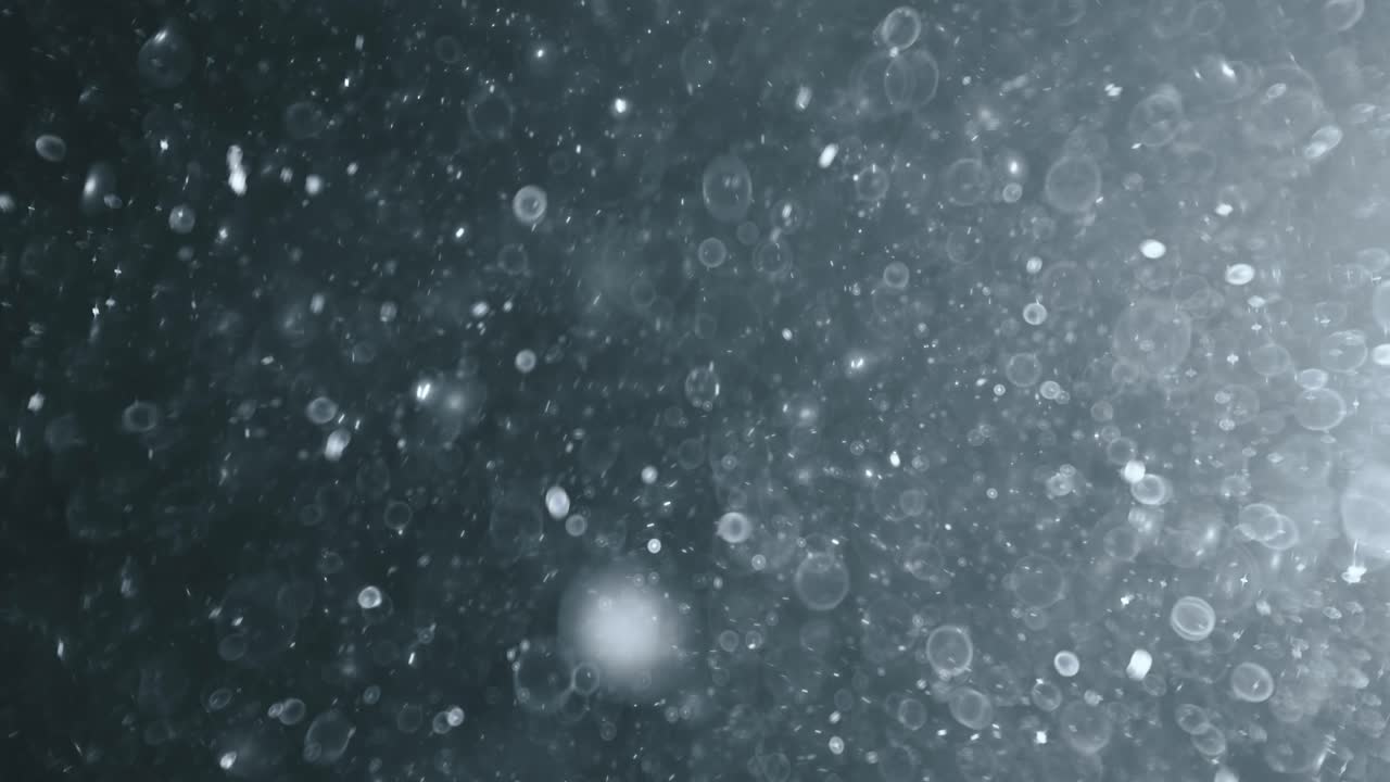 어두운 배경에 떠 있는 추상 입자 보케