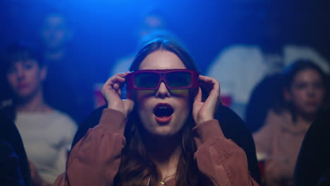 smiling girl putting on 3d glasses.