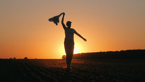 woman enjoying sunset run in a field