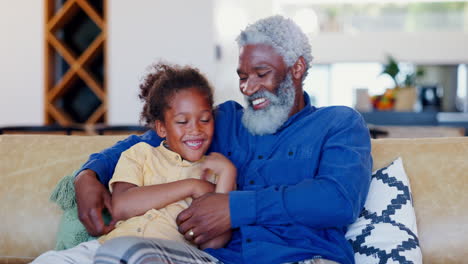 child, grandfather and tickle on sofa in home