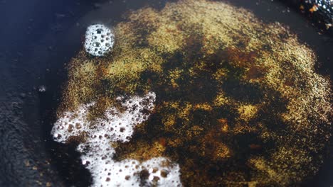 greasy pan with water and bubbles