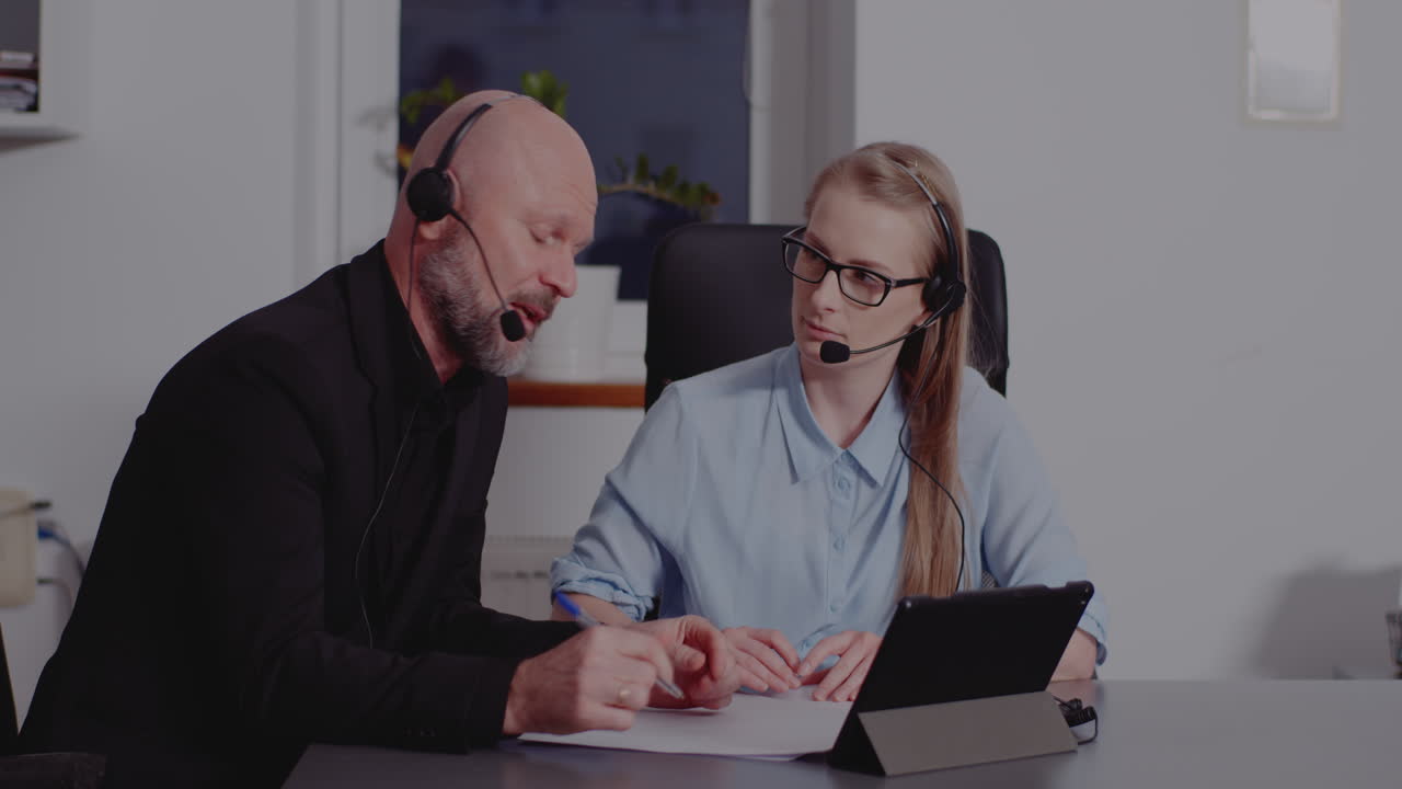 Two colleagues discussing work at the office