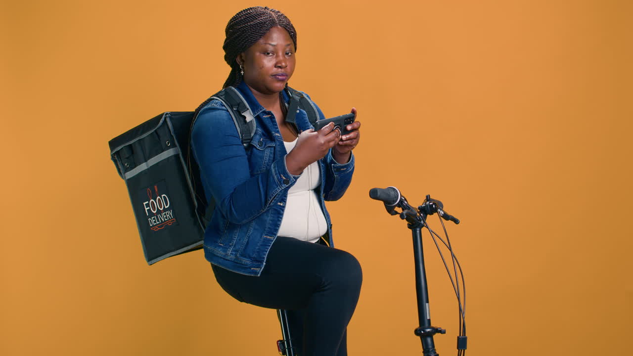 Woman Using Phone And Bicycle For Job