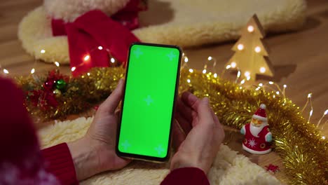 green screen pnone in hands. close up. christmas concept
