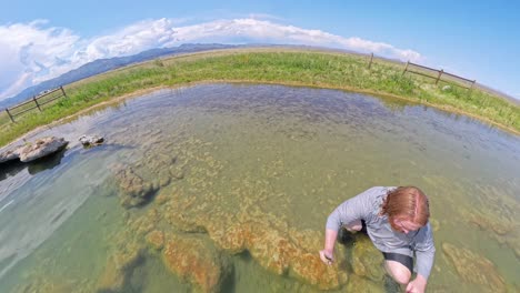hot spring in utah with a red haired male sitting in the water