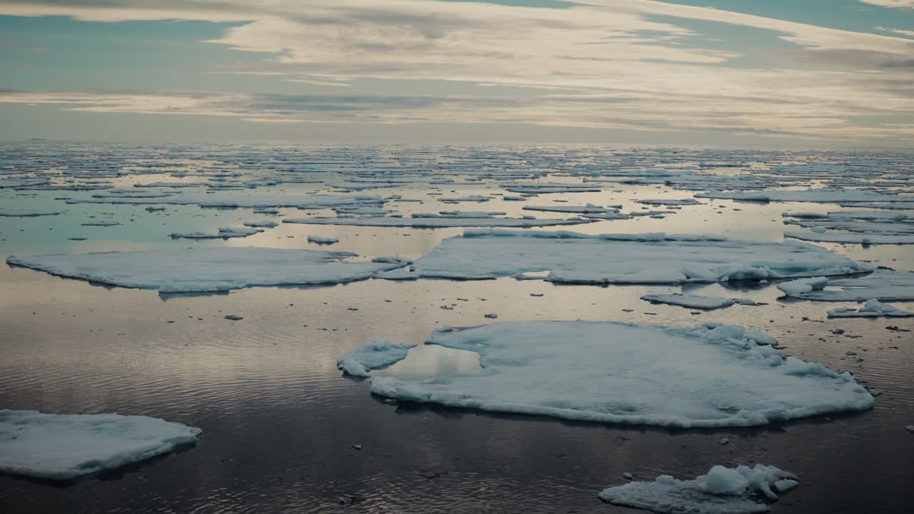 Travelling over Arctic sea ice and drifting floes under dramatic sky