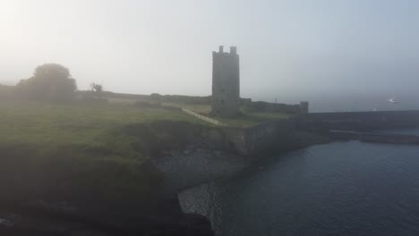 drone moving away from a moody carrigaholt castle loop head clare ireland