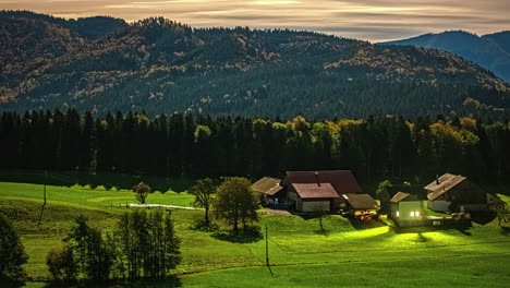 cinematic time lapse hills, mountain village fields with sunshine, grazing farm