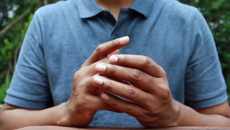 person sitting with hands crossed